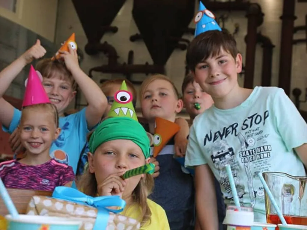 Children in party hats celebrating a birthday at Chocotopia